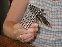 Balancing 13 nails on the head of a nail